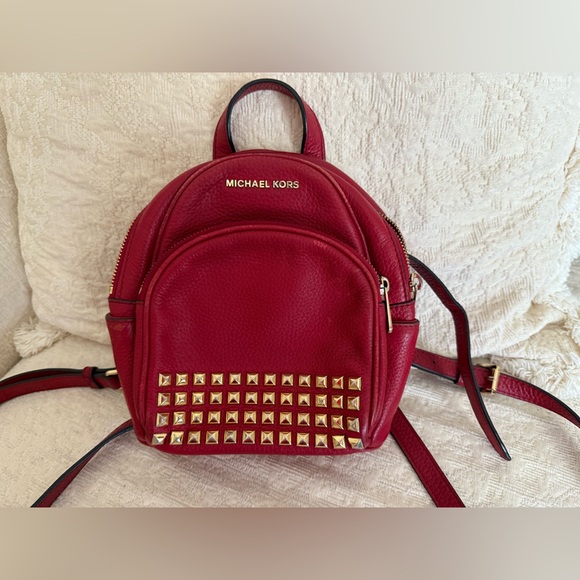 Michael Kors Handbags - Michael Kors Abbey XS Studded Red Backpack with Gold Studs
Size 7 by 8 by 3